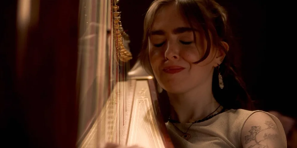 Yvonne plays with her eyes closed, lit warm gold